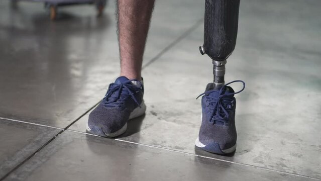 Closeup person wearing a prosthetic leg standing with artificial prosthesis