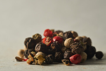 Details of a mountain of colored pepper on a white background