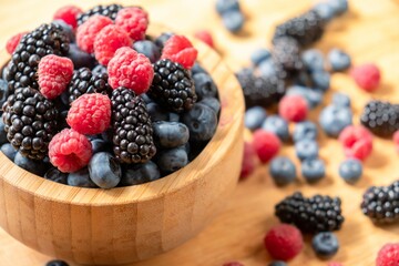 Food healthy blueberry berry organic. fruit whortleberry. Blueberries, raspberries, blackberries in a wooden bowl.
