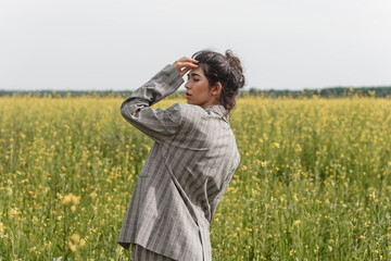 An Asian model poses in a field of yellow flowers for a clothing brand, polyethylene is the main...