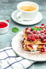Summer dessert, classic tiramisu with raspberry decorated with mint leaves. vertical image. top view