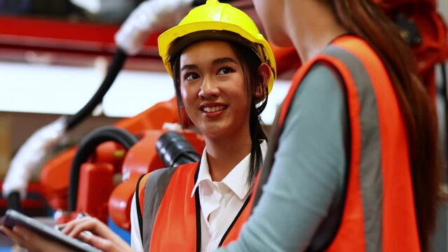 Group portrait Happy female factory manager and woman worker standing together at industrial warehouse factory. Portrait women worker working.
