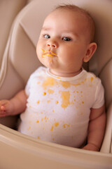 Stained messy baby boy refuses food