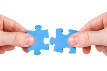 Two hands with different pieces of puzzle