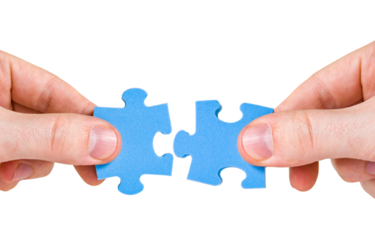 Two hands with different pieces of puzzle - Powered by Adobe