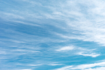 Fototapeta premium Blue sky with white clouds in sunny day. Beauty clear cloudy sky in sunshine calm air bacground. Natural background texture, backdrop, wallpaper, element for design