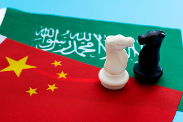 Two knights standing on Chinese flag and Saudi Arabia flag