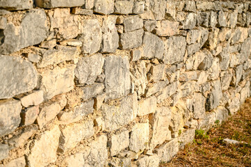 Stone wall in the field, close up. Medieval stone wall pattern.  