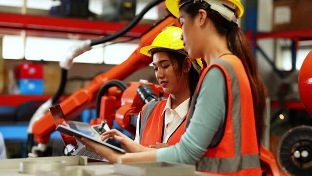 Group portrait Happy female factory manager and woman worker standing together at industrial warehouse factory. Portrait women worker working.