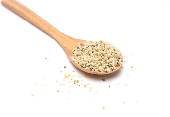 Hemp seeds on wooden spoon isolated on white background. high amgle view with copy space