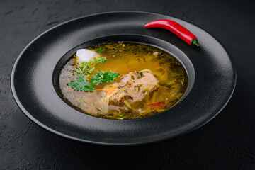 Chicken noodle soup in black plate