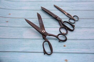 Antique scissors, on a wooden table, top view, space for text, selective focus,