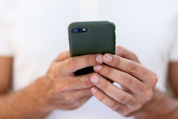 Closeup of man hands using mobile app shopping online, checking email, selective focus