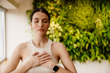 Young white woman doing breathing practice during meditation - 523785942