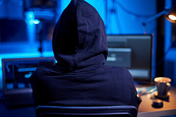 cybercrime, hacking and technology concept - close up of male hacker in dark room writing code or...