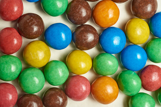 New MMs on a beige background. Background from a mms balloon. lots of sweets.