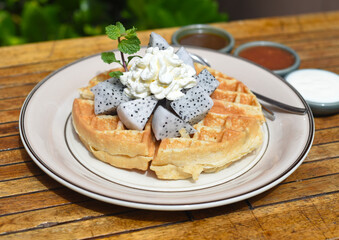 Belgium waffles with dragon fruit and ice cream on a plate