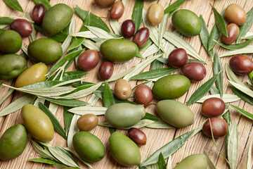 Mixed olives and green leaves background, close up view