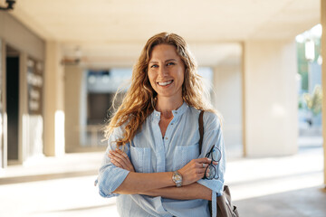 Portrait of a charming young woman posing for camera in the city