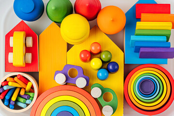 Colorful wooden toys in the colors of the rainbow in plastic box.  Concept of organizing and storing children's toys. Games for learning and development of the child.