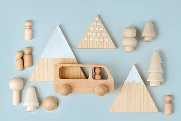 Washable wall murals Mountains Wooden play set forest, mountains and a bus on a blue background. Games for learning and development of the child. Cute kids toys  for decorating children's room.