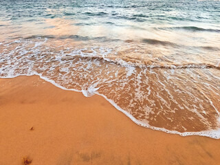 Sand beach background seaside with foamy sea wave