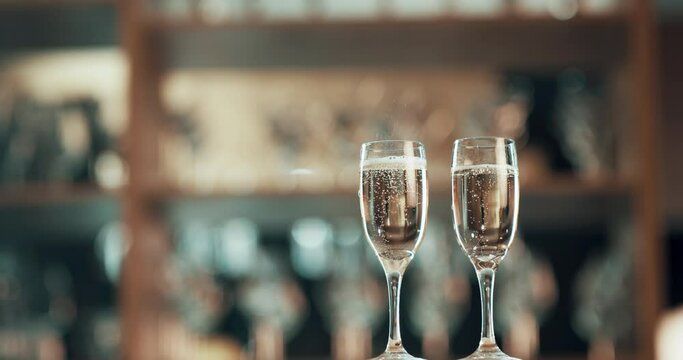 Glasses with champagne in a bar for celebration, anniversary or social party. Elegant, classy and fresh alcohol on a counter for drinking, achievement and birthday at a restaurant with copyspace