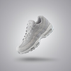 Light Gray sport sneaker, shoe on a gray gradient background, fashion, sport shoe,  air, sneakers, lifestyle, concept, product photo, levitation concept, street wear, trainer