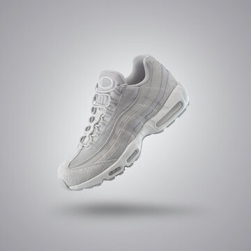 Light Gray sport sneaker, shoe on a gray gradient background, fashion, sport shoe,  air, sneakers, lifestyle, concept, product photo, levitation concept, street wear, trainer