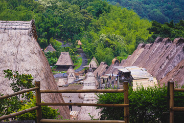 Bena a traditional village with grass huts of the Ngas people in Flores near Bajawa, Indonesia. Many small houses are made of natural parts like wood and straw. Giant volcano in the back