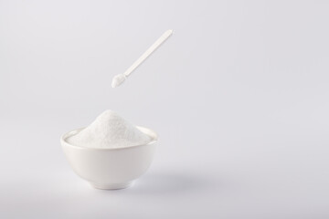 
Sugar substitute, Stevia in a white plate and in a small spoon. On a white background, a plate with a sugar substitute.