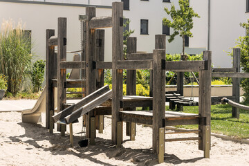 Children  Playground in new Residential Building complex. Modern Wooden Playground.