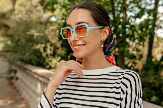 Close up profile portrait of elegant smiling attractive brunette woman with wonderful smile wearing casual shirt smiling on the street while walking in summer warm day