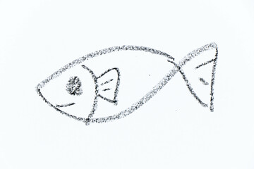 Black color crayon hand drawing in fish shape on white paper background