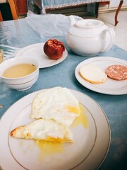[Uzbekistan] Scenery of breakfast (fried egg, pomegranate, cheese, and tea) at the hotel (Khiva)