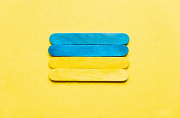 Flag of Ukraine on a yellow background. Ukraine's Independence Day. Ukraine. Flag of ukraine from wooden sticks on a yellow background.