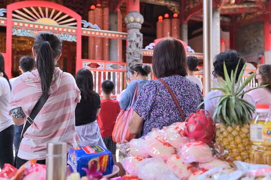 Taipei - July 17, 2022: Believers prepare rich offerings and worship the gods reverently.