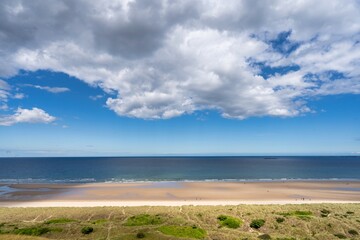 beach and clouds, tricolour of the sea, sandy beach and the field, background with copy space