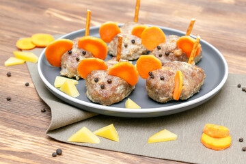 Small meatball mouse, meatloaf mice with ears of carrot, cheese on plate, creative and fun food snack idea for kids party. Menu for spooky Halloween dessert treats, edible cute rat selective focus