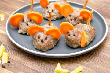 Small meatball mouse, meatloaf mice with ears of carrot, cheese on plate, creative and fun food snack idea for kids party. Menu for spooky Halloween dessert treats, edible cute rat selective focus