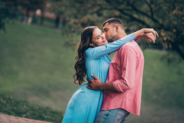 Fototapeta premium Photo of charming sweet two people together wear casual outfits cuddling kissing cheek outside garden