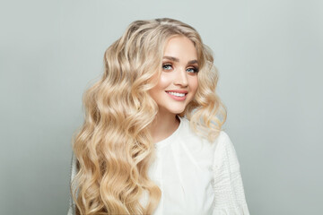 Portrait of attractive woman with long healthy perfect wavy hair against white background