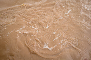 Muddy strong water inundation from the hill side due to heavy storm weather, Disaster scene photo.