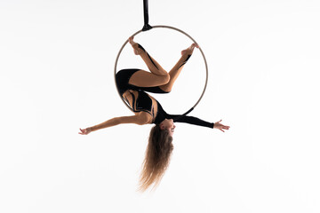 Slim and flexible circus Girl In aerial hoop isolated On White Background