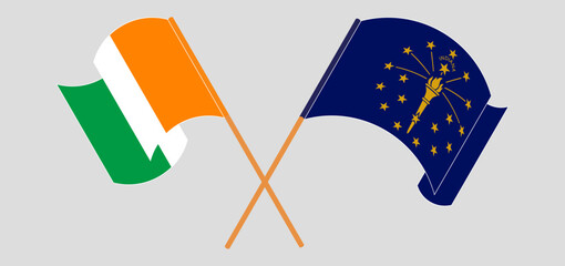 Crossed and waving flags of Ivory Coast and the State of Indiana