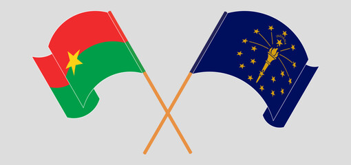 Crossed and waving flags of Burkina Faso and the State of Indiana