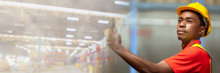 Web banner A man in charge of a large warehouse is checking the number of items in the warehouse that he is responsible for with copy space on left