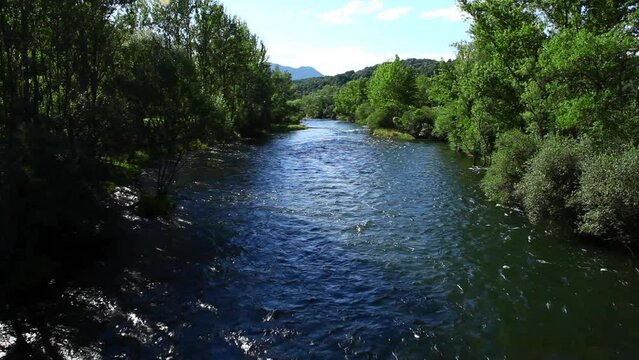 Sabero river in the province of Leon. lush green trees