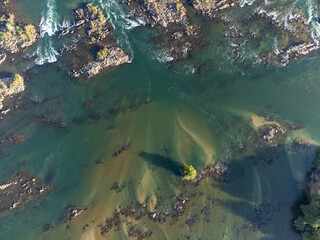 river bird top view with rocks, sand and forest