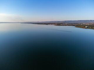 Green piece of land with trees on the banks of the great lake of the Tocantins River in Palmas